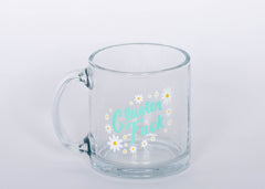 "Cluster Fuck Mug" Glass mug with blue type and white and yellow flower design.